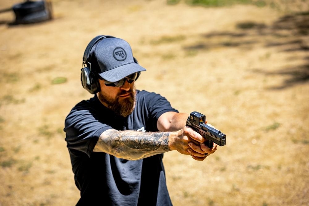 a man shooting cz p10c ported pistol